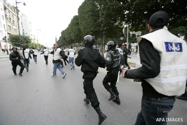 Tunisians take part in a protest in front of the headquarters of the Constitutional Democratic Rally (RCD) party of ousted president Zine al-Abidine Ben Ali during a demonstration in downtown Tunis, January 20, 2011. Tun...