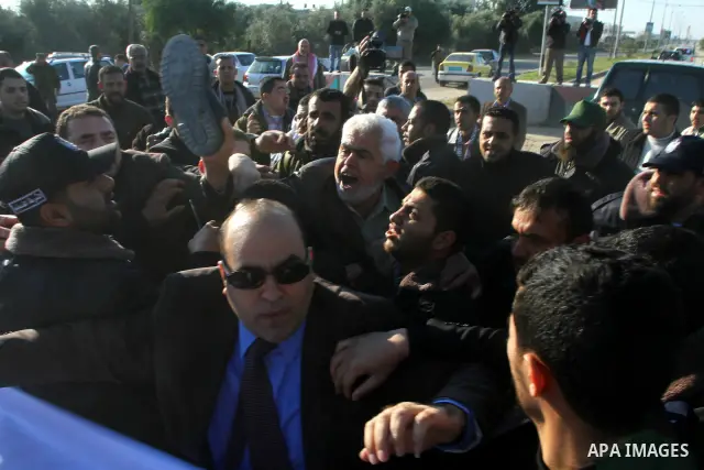 Palestinian relatives of a prisoners jailed in Israel hold posters as they block the vehicle carrying French Foreign Minister Michele Alliot-Marie as it makes its way into Gaza Strip, on the Palestinian side of the Erez...