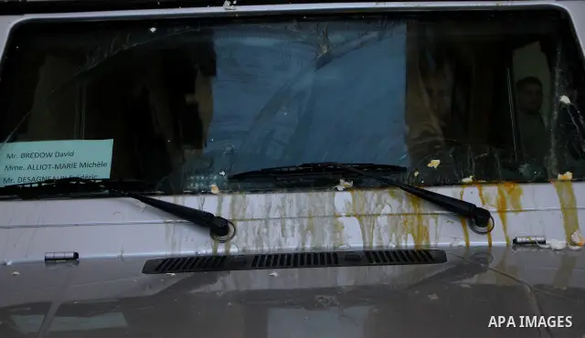 Broken eggs rest on the bonnet of a car belonging to the entourage of French Foreign Minister Michele Alliot-Marie during her visit to Al-Quds hospital in Gaza City, on Jan. 21, 2011. A crowd of furious Palestinian prote...