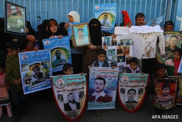 Relatives of Palestinians being held in Israeli jails hold pictures of them as French Foreign Minister Michele Alliot-Marie visits U.N. headquarters in Gaza City, on Jan. 21, 2011. A crowd of furious Palestinian proteste...