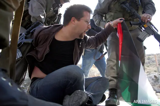 Israeli soldiers arrest a demonstrator during a protest against Israel's controversial separation barrier in the West Bank village of Maasarah, near Bethlehem, on January 21, 2011. Israel says the network of steel and co...