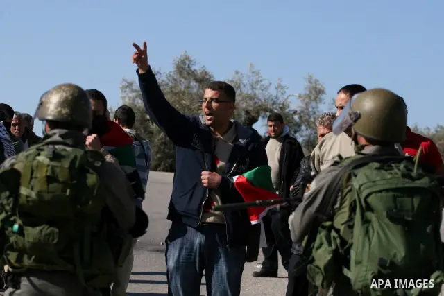 Palestinian protesters take part in a demonstration against the expansion of the nearby Jewish settlement of Halamish in the West Bank village of Nabi Saleh, near Ramallah, Friday, Jan. 21, 2011. Photo by Issam Rimawi