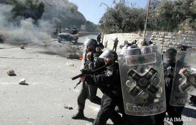 Israeli soldiers take position during clashes with Palestinian youths in the Arab east Jerusalem neighbourhood of Silwan on January 21, 2011. Photo by Mahfouz Abu Turk