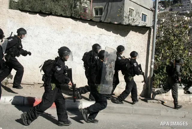 Israeli soldiers take position during clashes with Palestinian youths in the Arab east Jerusalem neighbourhood of Silwan on January 21, 2011. Photo by Mahfouz Abu Turk