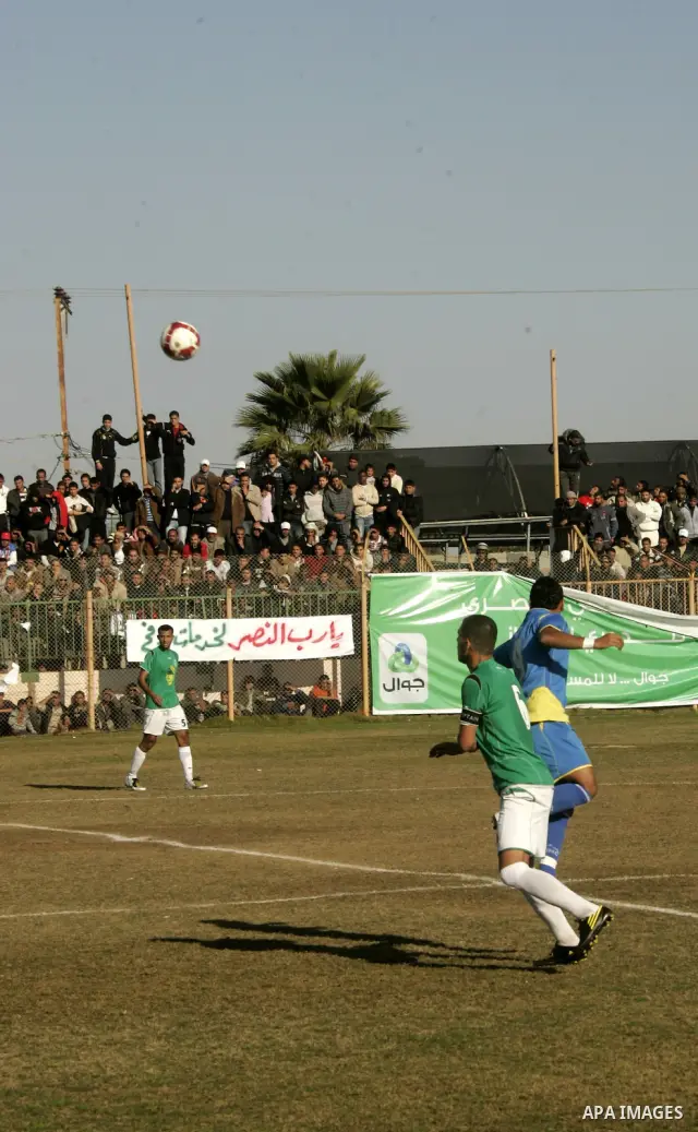 Players from Rafah Youth Club play against the players from Rafah Services Club during a football match in the league of the Gaza Strip at Rafah Municipality Stadium in the southern Gaza Strip on January 21, 2011. Photo...