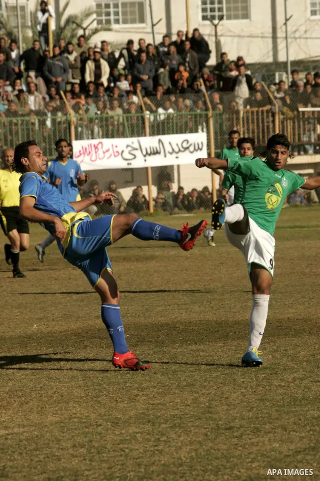 Players from Rafah Youth Club play against the players from Rafah Services Club during a football match in the league of the Gaza Strip at Rafah Municipality Stadium in the southern Gaza Strip on January 21, 2011. Photo...