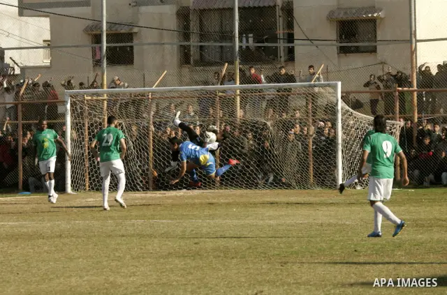 Players from Rafah Youth Club play against the players from Rafah Services Club during a football match in the league of the Gaza Strip at Rafah Municipality Stadium in the southern Gaza Strip on January 21, 2011. Photo...
