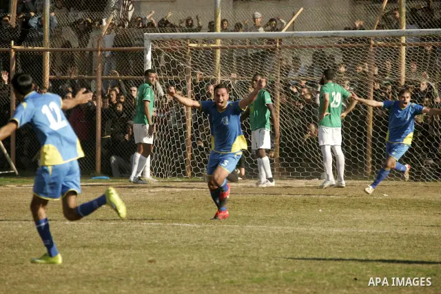 Players from Rafah Youth Club play against the players from Rafah Services Club during a football match in the league of the Gaza Strip at Rafah Municipality Stadium in the southern Gaza Strip on January 21, 2011. Photo...