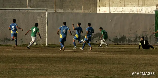 Players from Rafah Youth Club play against the players from Rafah Services Club during a football match in the league of the Gaza Strip at Rafah Municipality Stadium in the southern Gaza Strip on January 21, 2011. Photo...