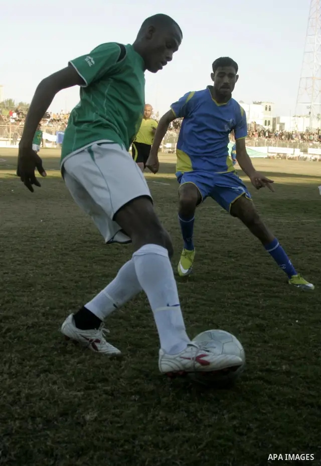 Players from Rafah Youth Club play against the players from Rafah Services Club during a football match in the league of the Gaza Strip at Rafah Municipality Stadium in the southern Gaza Strip on January 21, 2011. Photo...