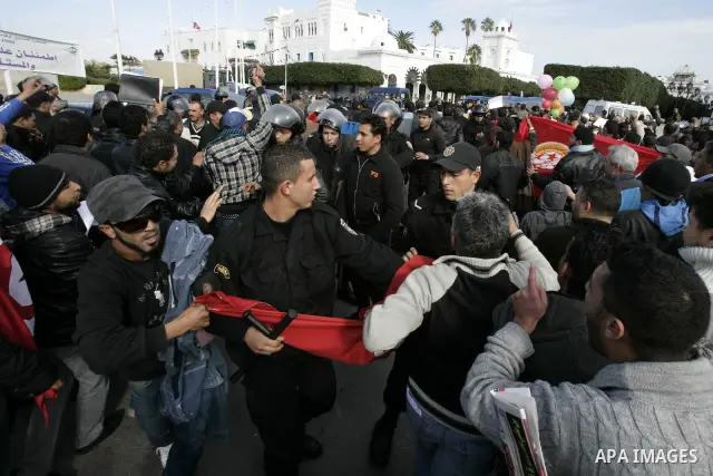 Protestors shout slogans in front of the Prime Minister's office in Tunis, Friday, Jan. 21 2011. Several hundred demonstrators also gathered peacefully across from the long-dreaded Interior Ministry in central Tunis, cha...