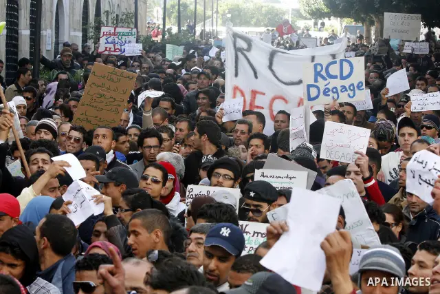 Protestors shout slogans in front of the Prime Minister's office in Tunis, Friday, Jan. 21 2011. Several hundred demonstrators also gathered peacefully across from the long-dreaded Interior Ministry in central Tunis, cha...