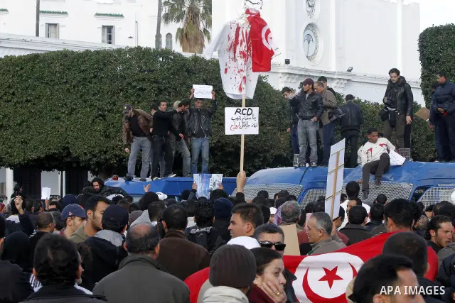 Protestors shout slogans in front of the Prime Minister's office in Tunis, Friday, Jan. 21 2011. Several hundred demonstrators also gathered peacefully across from the long-dreaded Interior Ministry in central Tunis, cha...