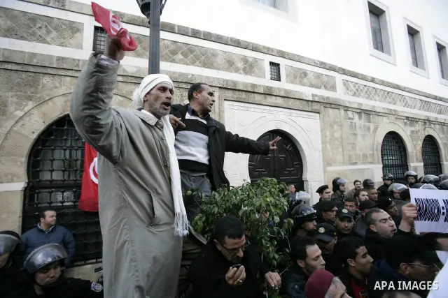 Protestors shout slogans in front of the Prime Minister's office in Tunis, Friday, Jan. 21 2011. Several hundred demonstrators also gathered peacefully across from the long-dreaded Interior Ministry in central Tunis, cha...