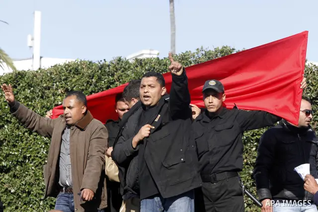 Protestors shout slogans in front of the Prime Minister's office in Tunis, Friday, Jan. 21 2011. Several hundred demonstrators also gathered peacefully across from the long-dreaded Interior Ministry in central Tunis, cha...
