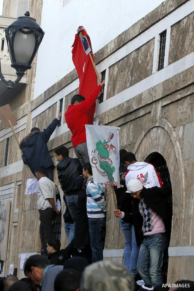 Protestors shout slogans in front of the Prime Minister's office in Tunis, Friday, Jan. 21 2011. Several hundred demonstrators also gathered peacefully across from the long-dreaded Interior Ministry in central Tunis, cha...