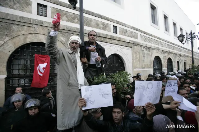 Protestors shout slogans in front of the Prime Minister's office in Tunis, Friday, Jan. 21 2011. Several hundred demonstrators also gathered peacefully across from the long-dreaded Interior Ministry in central Tunis, cha...