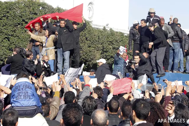 Protestors shout slogans in front of the Prime Minister's office in Tunis, Friday, Jan. 21 2011. Several hundred demonstrators also gathered peacefully across from the long-dreaded Interior Ministry in central Tunis, cha...