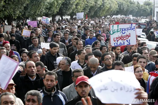 Protestors shout slogans in front of the Prime Minister's office in Tunis, Friday, Jan. 21 2011. Several hundred demonstrators also gathered peacefully across from the long-dreaded Interior Ministry in central Tunis, cha...