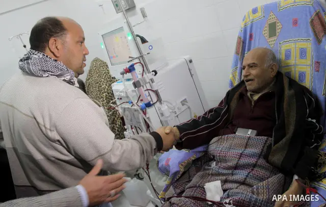 A member of the Libyan convoy " Al-Quds 5 " shake hands with a Palestinian patient during their visit to Al-Shifa Hospital, in Gaza City on Jan. 22, 2011. Photo by Mohammed Asad