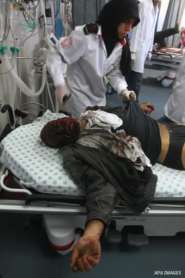 A wounded Palestinian youth receives a treatment at al-Shifa hospital in Gaza City, Jan. 22, 2011. A Palestinian was killed and three were wounded Saturday when a leftover ordnance from previous Israeli shelling exploded...