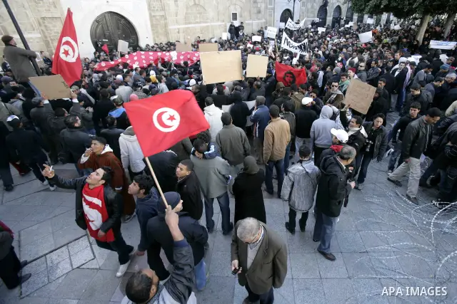 Tunisians hold placards during a demonstration to demand a new government free of officials of the ousted regime of former president Zine el Abidine Ben Ali, goes on in central Tunis, Tunisia, 23 January 2011. According...