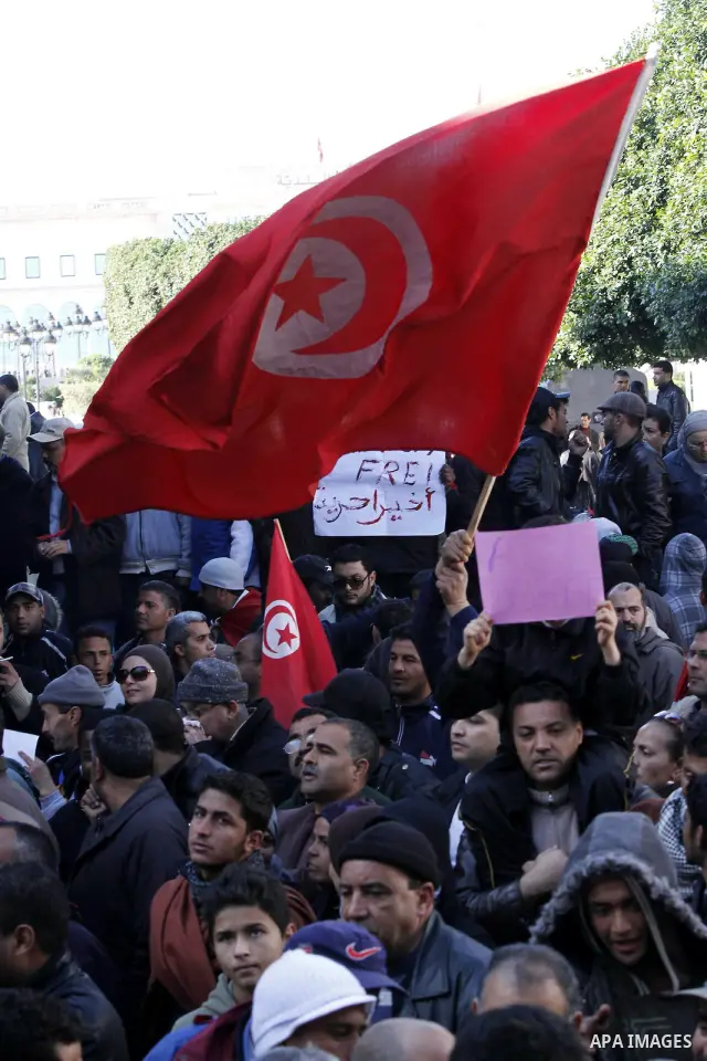 Tunisians hold placards during a demonstration to demand a new government free of officials of the ousted regime of former president Zine el Abidine Ben Ali, goes on in central Tunis, Tunisia, 23 January 2011. According...