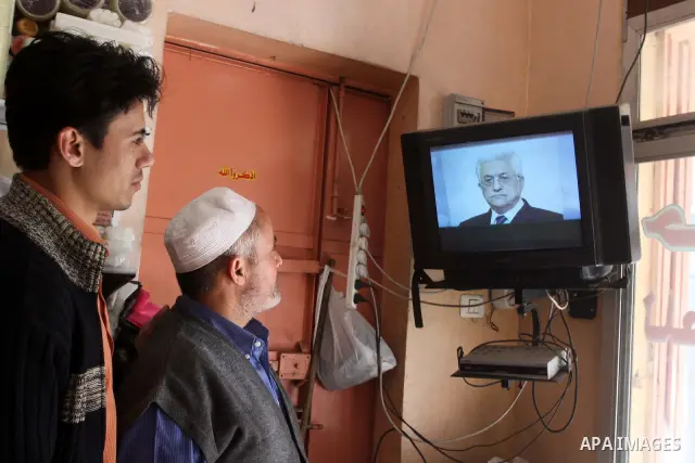 Palestinians watch Al-Jazeera channel at their shops, in Gaza City on Jan. 24, 2011. Al-Jazeera yesterday, revealed leaked documents recorded during the negotiations that occur between the Palestinian Authority and the I...