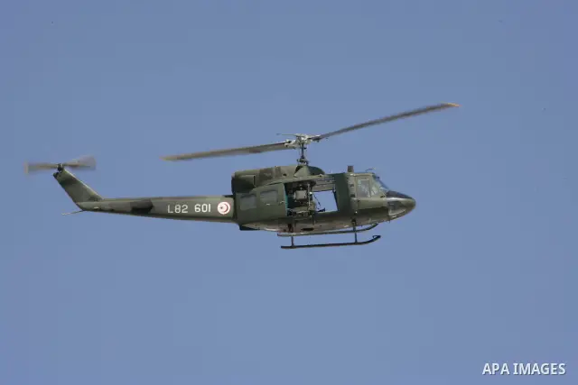A military helicopter is seen as Tunisian protesters gather to demand a new government free of officials of the ousted regime of former president Zine el Abidine Ben Ali, near the Prime Minister's office in Tunis, Tunisi...