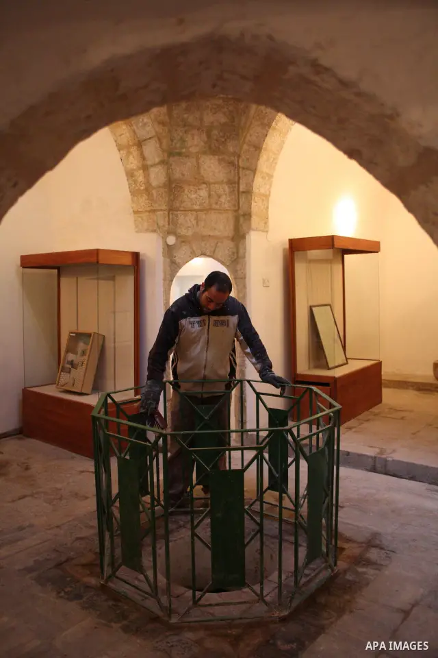 A Palestinian laborer works near a callgraphic works during the opening of the ( Old City Museum ) in the old city of the West Bank city of Hebron on January 25, 2011. The museum located in " Haret Dari " near the Khan a...