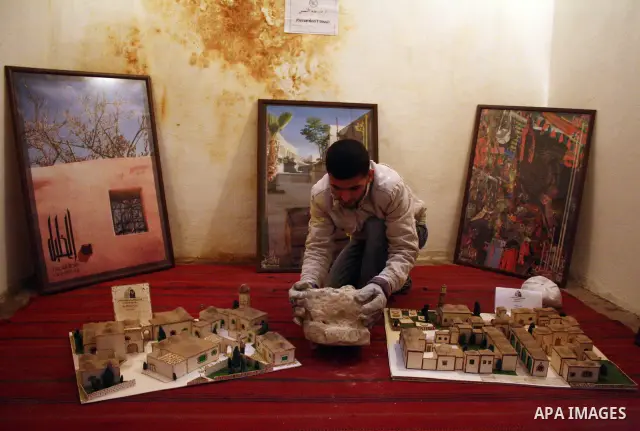 A Palestinian laborer works near a callgraphic works during the opening of the ( Old City Museum ) in the old city of the West Bank city of Hebron on January 25, 2011. The museum located in " Haret Dari " near the Khan a...