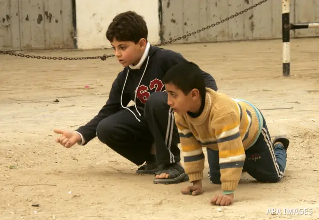 Palestinian children play in alley in the Rafah refugee camp in the southern Gaza Strip on January 25, 2011, a day after it was leaked by Al-Jazeera in revealed documents that Palestinian negotiators accepted Israel's pr...
