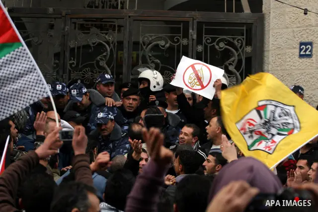 Palestinians supporters of the President Mahmoud Abbas gather next to Al-Jazeera office in the West Bank town of Ramallah, to protest against Al-Jazeera TV Channel on 25 January 2011. Palestinian negotiators privately ag...