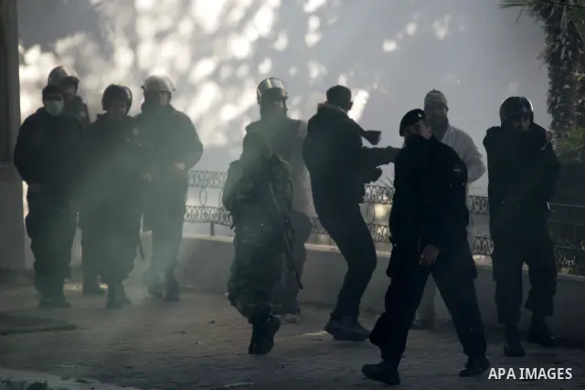 Tunisian policemen fire tear gas canisters at protestors during a demonstration against Prime Minister Mohammed Ghannouchi in front of the government palace in Tunis.Tunisia, 26 January 2011, Hundreds of defiant Tunisian...