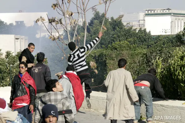 Tunisian policemen fire tear gas canisters at protestors during a demonstration against Prime Minister Mohammed Ghannouchi in front of the government palace in Tunis.Tunisia, 26 January 2011, Hundreds of defiant Tunisian...