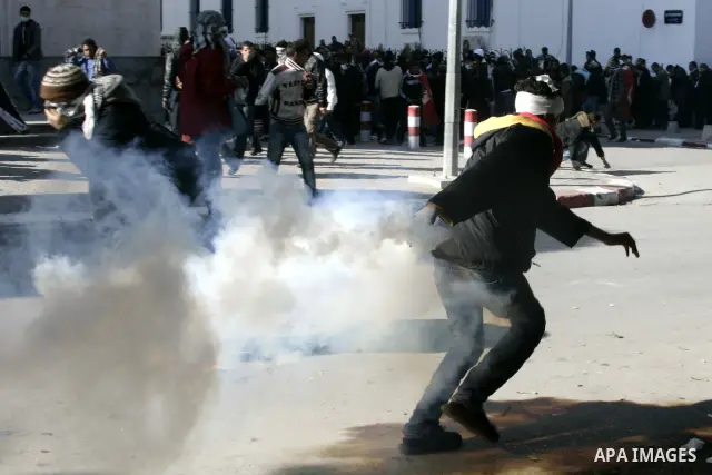 Tunisian policemen fire tear gas canisters at protestors during a demonstration against Prime Minister Mohammed Ghannouchi in front of the government palace in Tunis.Tunisia, 26 January 2011, Hundreds of defiant Tunisian...