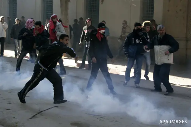 Tunisian policemen fire tear gas canisters at protestors during a demonstration against Prime Minister Mohammed Ghannouchi in front of the government palace in Tunis.Tunisia, 26 January 2011, Hundreds of defiant Tunisian...