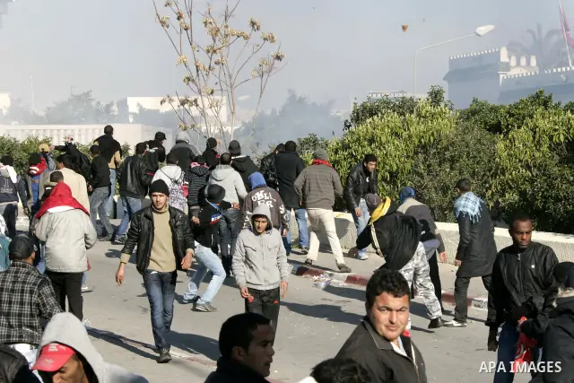 Tunisian policemen fire tear gas canisters at protestors during a demonstration against Prime Minister Mohammed Ghannouchi in front of the government palace in Tunis.Tunisia, 26 January 2011, Hundreds of defiant Tunisian...