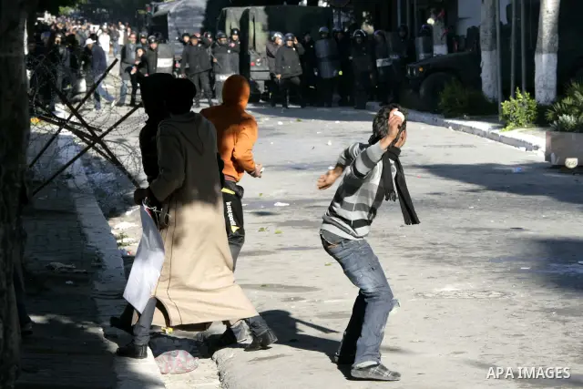 Tunisian policemen fire tear gas canisters at protestors during a demonstration against Prime Minister Mohammed Ghannouchi in front of the government palace in Tunis.Tunisia, 26 January 2011, Hundreds of defiant Tunisian...