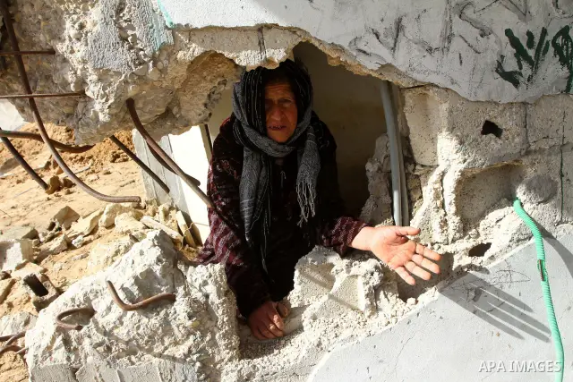 A Palestinian woman sits in her home which was partially destroyed during the Israeli war on Gaza in Jabalya in the northern Gaza Strip Jan. 26, 2011. a day after leaked documents were published by Al-Jazeera, showing Pa...