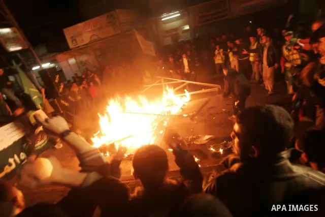 Palestinian Hamas activists take part rally against Abbas, following a recent broadcast by Al-Jazeera reportedly linking him to making broad concessions to Israel in peace talks, in Rafah, southern Gaza Strip, Wednesday,...