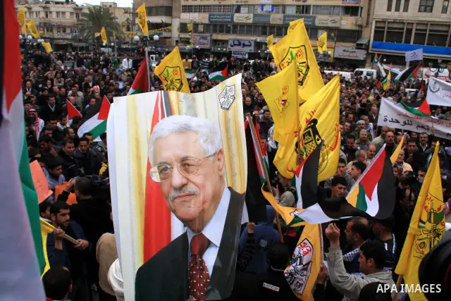 Palestinians hold Fatah flags and national flags during a rally in the West Bank City of Nablus , to protest against Al-Jazeera TV Channel on 27 January 2011. Al-Jazeera, a Qatar-based Arab satellite station, this week p...