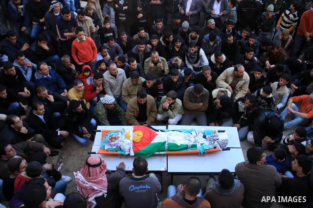 Palestinian mourners surround the body of Uday Qadous, 18, who was shot and killed Thursday in the village of Iraq Burin, during his funeral at in the West Bank city of Nablus, Friday Jan. 28, 2011. Israeli police spokes...