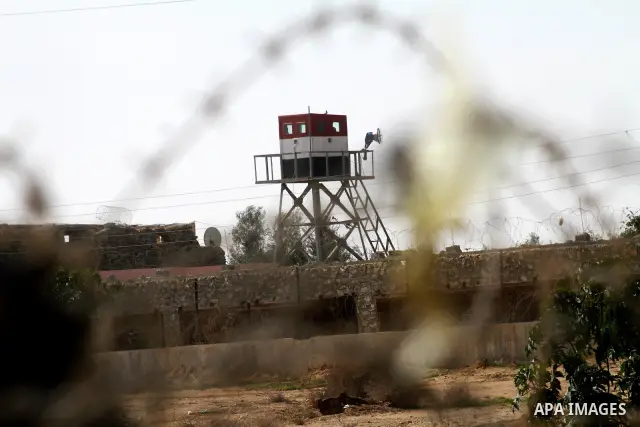 An Egyptian control tower is seen behind barbed wire at the Egyptian border with the Gaza Strip in the city of Rafah, southern Gaza Strip on, 28 January 2011. The Egyptian authorities intensified security measures on the...
