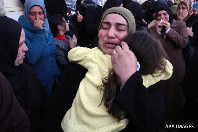 Palestinian women mourn during the funeral of Youssef Ekhaleil in the West Bank village of Beit Omar, near Hebron, Saturday, Jan. 29, 2011. Ekhaleil died from wounds sustained during a clash with settlers on Friday Photo...