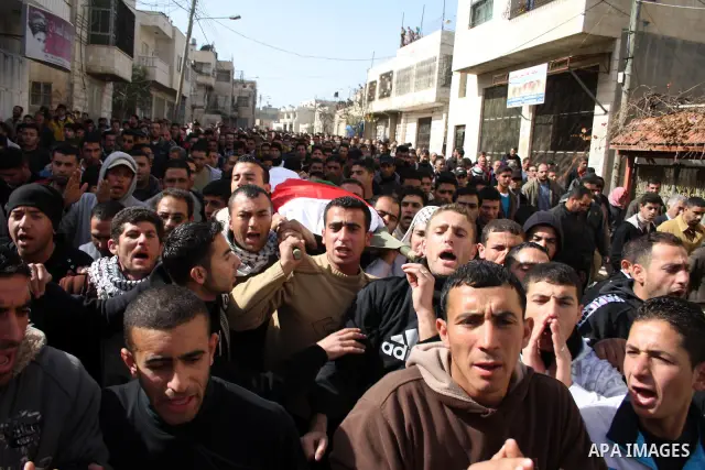 Palestinians carry the body of Youssef Ekhaleil during his funeral in the West Bank village of Beit Omar, near Hebron, Saturday, Jan. 29, 2011. Ekhaleil died from wounds sustained during a clash with settlers on Friday P...