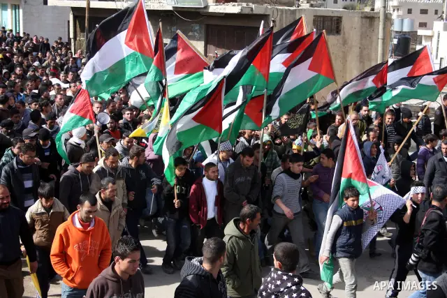 Palestinians carry the body of Youssef Ekhaleil during his funeral in the West Bank village of Beit Omar, near Hebron, Saturday, Jan. 29, 2011. Ekhaleil died from wounds sustained during a clash with settlers on Friday P...