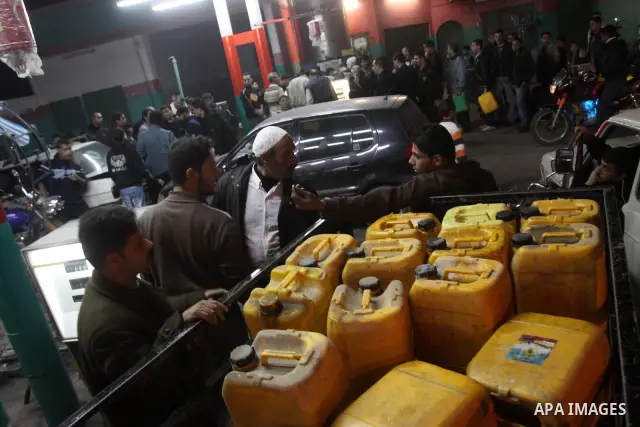 Palestinians gather at a petrol station in Gaza city on Jan 29,2011, as Palestinians rush to petrol stations for fear of being cut off petrol which smuggled from tunnels between Gaza and Egypt as a result of the developm...