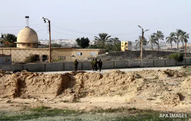 Palestinian security forces stand guard near the Egyptian border with the Gaza Strip in the city of Rafah, southern Gaza Strip on, 29 January 2011. The embattled Mubarak tapped Egypt's military intelligence chief as his...