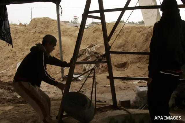 Palestinians work in a smuggled tunnel on the border between Egypt and Gaza in Rafah, southern Gaza Strip on January, 30, 2011. at least two of the prisoners who had been held in Abu Zaabal prison, northeast of Cairo, ha...